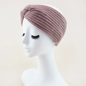 Detailed view of the cozy knitted twist headband in mauve, showing soft ribbed texture.