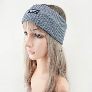 Close-up detail of grey knitted headband with stylish black label for comfortable daily wear.