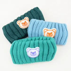 Detailed view of the knitted bear headband, featuring soft woolen fabric and cute embroidery.