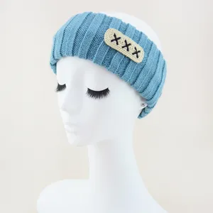 Blue knitted headband detail, soft woolen hair band with embroidered patch, daily hair accessory.