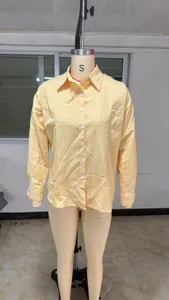 Yellow plaid long sleeve shirt detail shot showing lapel and buttons clearly.