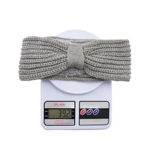 Grey knitted fleece headband detail showing weight, warm bow winter hair accessory specs.