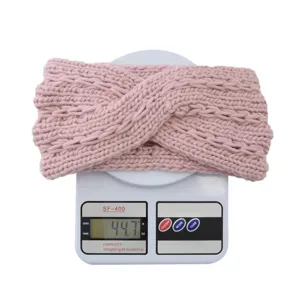 Pink chunky knit twist headband detail shot, cozy winter hair accessory for women.