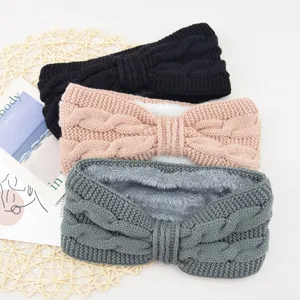 Detailed closeup view of thick cable knit fleece-lined winter headbands in black, pink and grey.