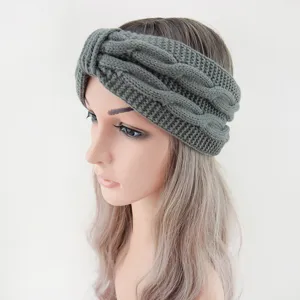 Close-up detail of the dark green knitted twist headband, showing soft woolen texture and cozy fit.