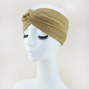 Detailed close-up view showing the textured khaki bubble fabric cross headband design.