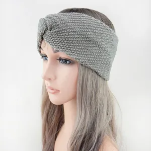 Detailaufnahme eines grauen gestrickten Stirnbands, kuscheliges Woll-Haaraccessoire für den Winter.