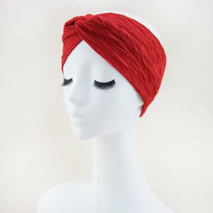 Red crinkle fabric knotted headband, detailed view of the elastic wide hairband for yoga and face washing.