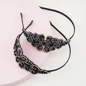 Close-up of black crystal beaded headband, showing fine wire and sparkling crystal details.