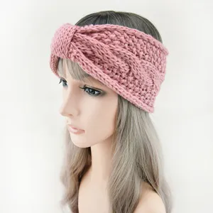 Detailed close-up of a pink knitted twist headband, cozy winter ear warmer accessory.