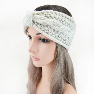 Detail view of a beige chunky cable knit headband, perfect winter ear warmer hair accessory.