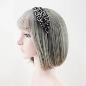 Detailed side view of a black crystal beaded floral headband on mannequin for elegant party wear.