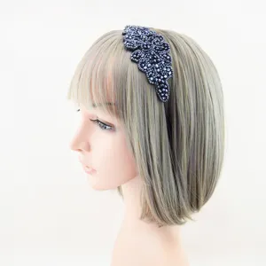 Detail shot of a dark crystal beaded headband on a mannequin head, showing fine craftsmanship.