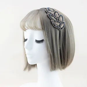 Detailed view of handmade crystal rhinestone headband, exquisite alloy leaf hair accessory design.