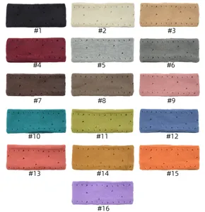 Detailed view of colorful knitted headbands with distressed holes, ideal for sports and yoga.