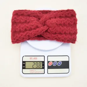 Red fuzzy knit headband detail shot, soft plush warm ear cover winter hair accessory