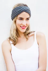 Nahaufnahme eines grauen gestrickten Twist-Stinbades, weiches Winter-Haaraccessoire.
