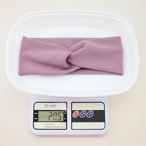 Detailed view of a purple twisted athletic headband shown on a digital scale for weight check.