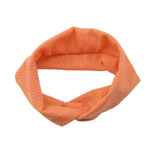 Detail shot of orange ribbed cross hairband, breathable elastic fabric for sports and daily.