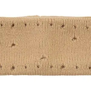 Close-up view of beige knitted fabric texture with hollow-out distressed holes detail.