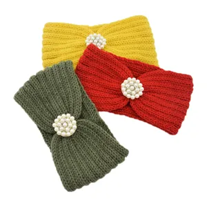 Knitted headband detail showing the soft yarn texture and elegant pearl flower decoration clearly.