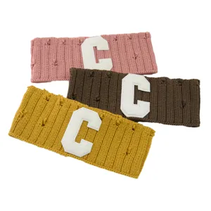 Knit headband set with letter C patch and distressed detail, soft stretch winter hair accessory.
