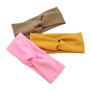 Detailed view of elastic cross headband, soft breathable fabric for sports, yoga and face washing.