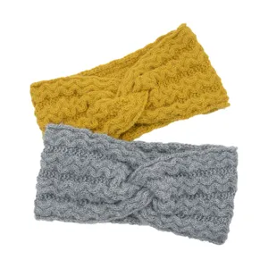 Detail view of knitted winter headband, cross wavy wool hair band, warm and cozy.