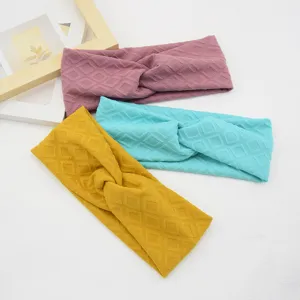 Close-up detail of cross rhombus headbands in multiple colors for sports and yoga use.