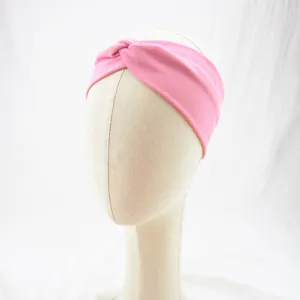 Pink knotted sports headband for women, breathable elastic fabric yoga and fitness hair band.