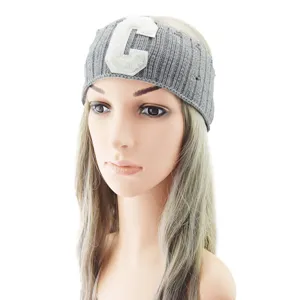 Grey knitted headband with a C letter patch and distressed details for sports and yoga.