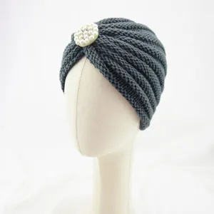 Detail view of a dark grey knitted turban hat featuring an elegant pearl rhinestone brooch.