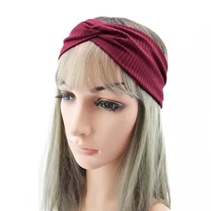 Close-up detail of the wine red ribbed twist headband, soft stretchy fabric, elegant hair accessory.
