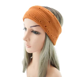 Orange knitted winter headband for women, double layer thermal ear warmer hair accessory.