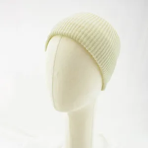 Detailed view of the solid color ribbed knit beanie cap in beige, soft texture and cozy wear.