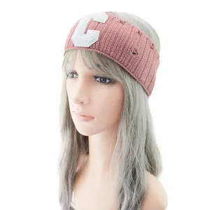 Pink distressed knit headband detail, cozy wool hair accessory with collegiate letter patch.