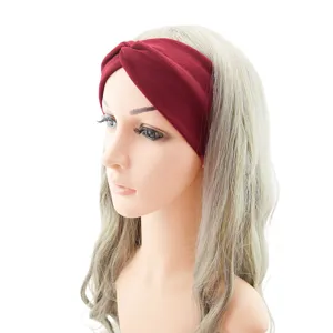 Detailed view of wine red knotted headband, soft elastic fabric for workout and yoga.