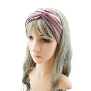 Detailed view of a soft velvet twisted headband in dusty pink, elastic fabric for daily wear.