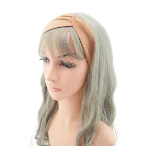 Closeup detail view of a stylish brown cross stretch fabric headband on a mannequin.