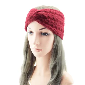 Detailed view of the red knit twist headband worn on a mannequin, showcasing texture and style.