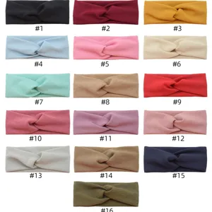 Comfortable stretch fabric twist headband in multiple colors, stylish sports hair accessory.