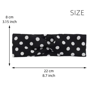 Detailed view of the black and white polka dot knotted headband with clear size marks.