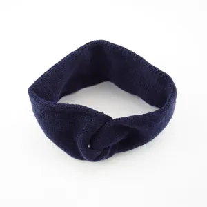 Dark blue knitted headband with front twist detail, soft and warm hair accessory for winter.