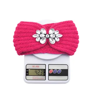 Detail shot of rhinestone knitted headband weight display on scale, fuzzy winter hair accessory.