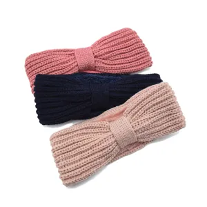 Detailed view of cozy fleece-lined knitted hair bands with cute bow design for winter warmth.
