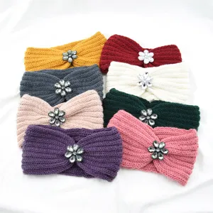 Detailed view of multi-color knitted headbands with sparkling rhinestone flower embellishments.