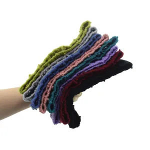 Close-up detail view of multi-color knitted elastic headbands stacked neatly, soft cotton.