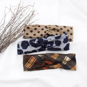 Close-up details of assorted print cross headbands, soft fabric style for daily wear.