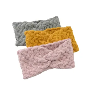 Detail view of cozy knit twist headbands in grey, yellow, and pink for winter warmth and daily hair styling.