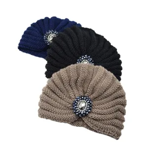 Detail shot of knitted turban hats featuring sparkling crystal embellishments in three versatile colors.